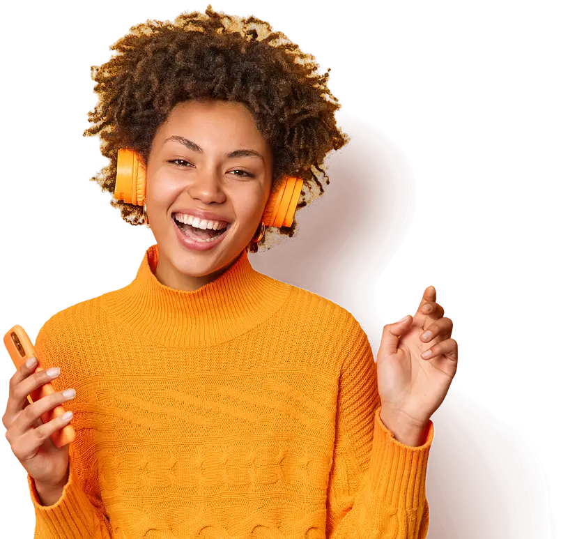 A woman with headphone holding a phone and looking excited